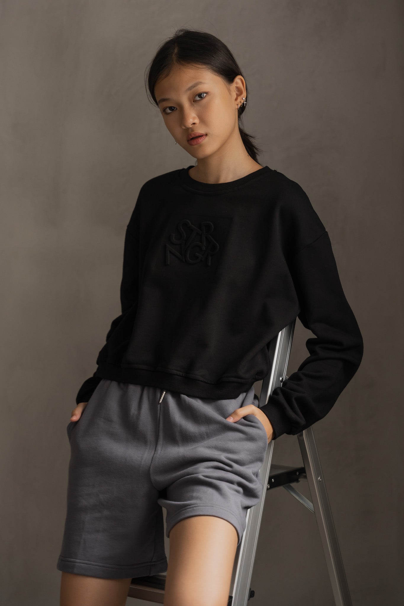 STRANGER Embossed Logo Cropped Sweatshirt in Black