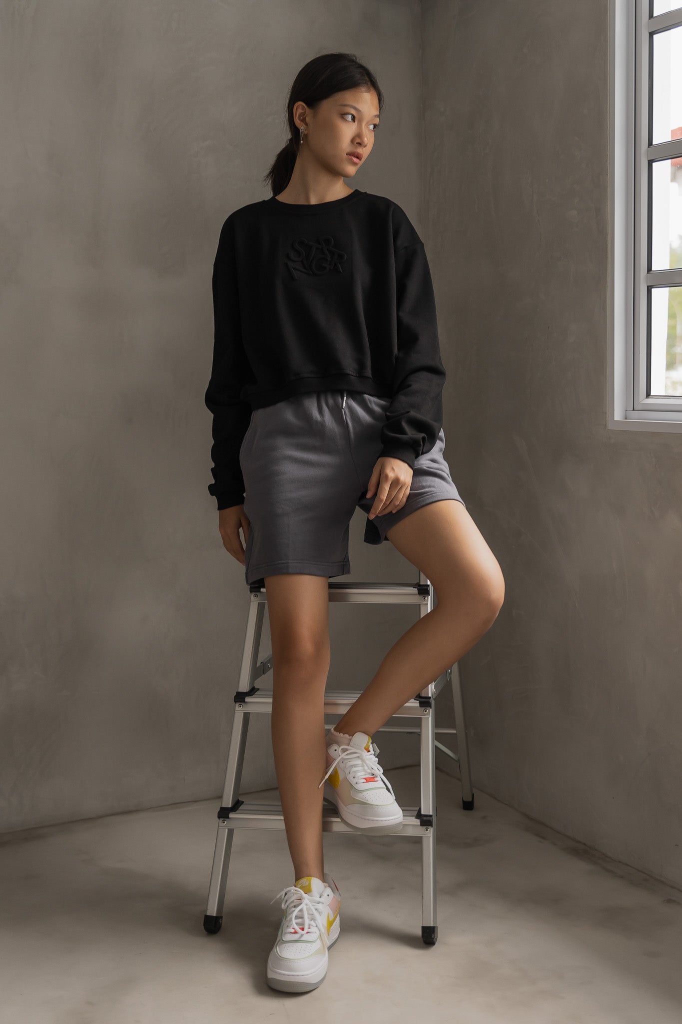 STRANGER Embossed Logo Cropped Sweatshirt in Black