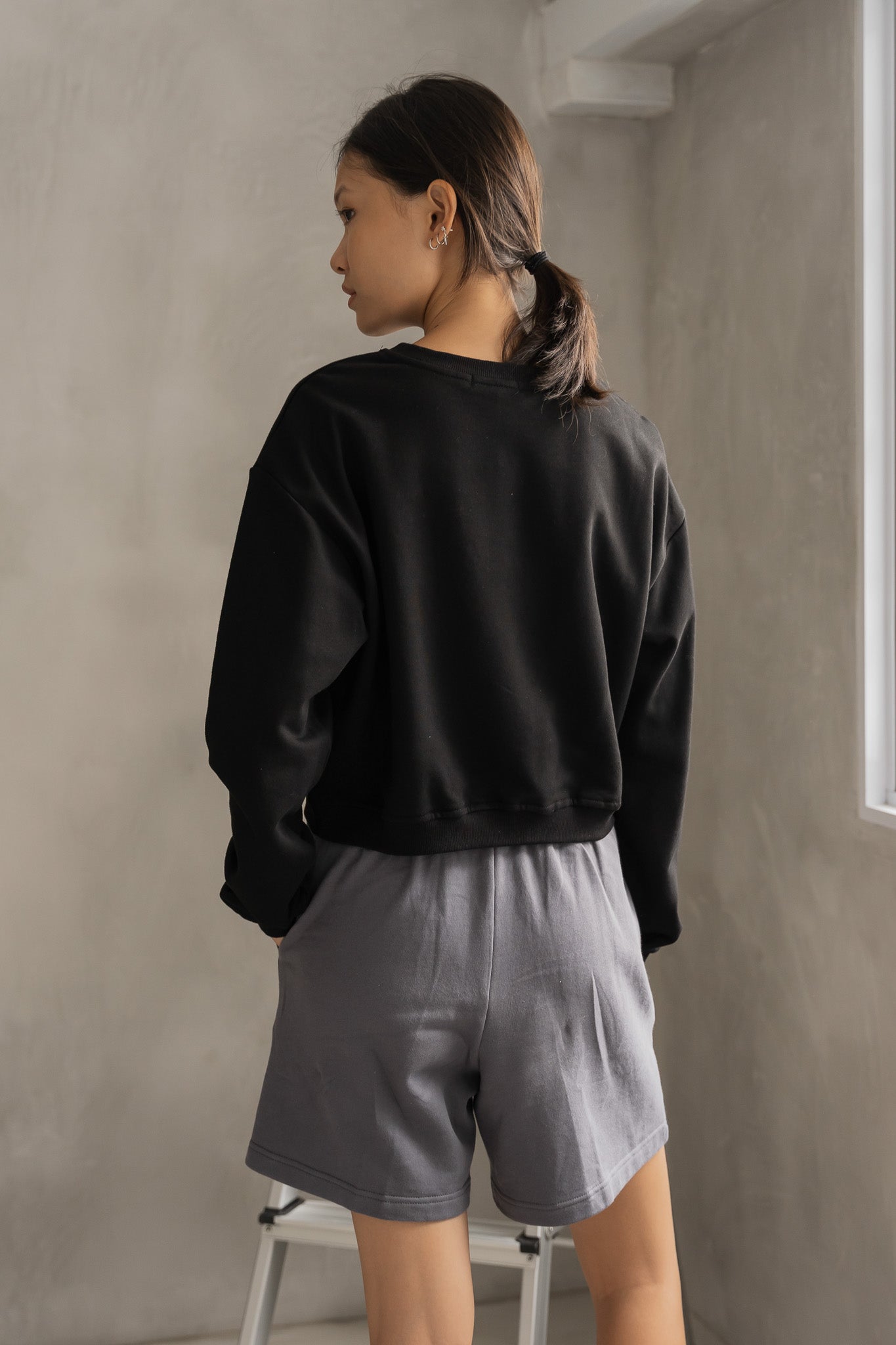 STRANGER Embossed Logo Cropped Sweatshirt in Black